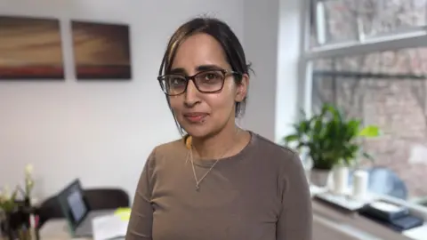 32 year old Sana Shaikh stood in her kitchen.