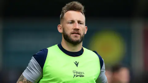 Byron McGuigan wearing Sale Sharks training gear