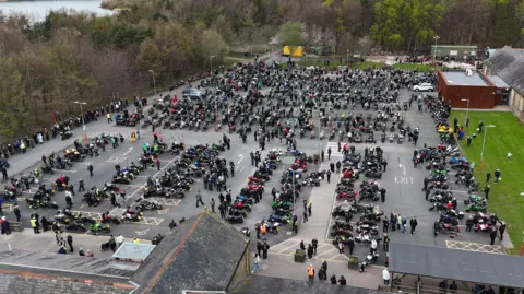 An aerial view of the carpark at the Woodhorn Museum. Hundreds of motorbikes are parked and their riders are walking about and talking to each other.