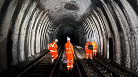 The Blackheath tunnel inspected by four men in orange jackets