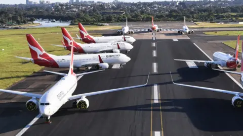 Getty Images Qantas planes grouped on the tarmac at Sydney Airport