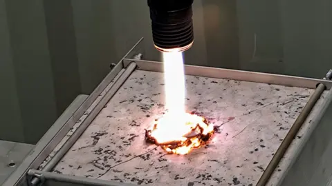 Quaise A bright beam of millimetre-waves blasts a test piece of rock.