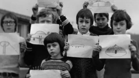 BBC/Twenty Twenty Productions Ltd Broad Haven Primary School children holding drawings of the UFO they had seen