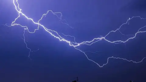 McPhetus Lightning across a dark blue sky 