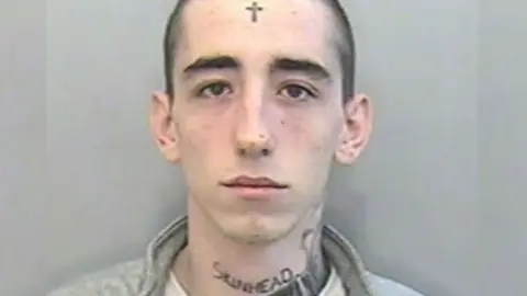 Devon and Cornwall Police mug shot of tattooed man