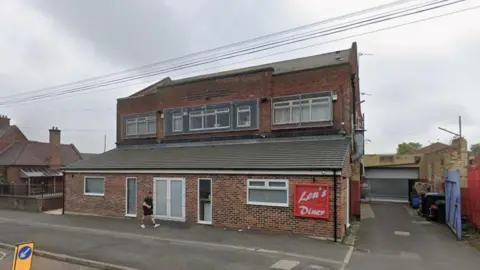 Lou's Diner in Fossway, Newcastle. It is a two-storey, red-brick building with a red sign.
