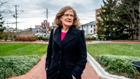 Loudoun County's Kristen Umstattd - standing in front of a set of buildings