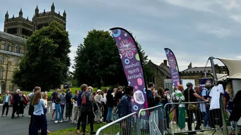 Durham Fringe People queueing outside a Durham Fringe tent on the city's Palace Green outside Durham Cathedral