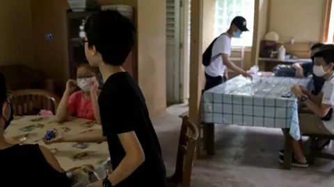 Reuters Children playing a traditional game in Singapore, which has one of the world's lowest birth rates