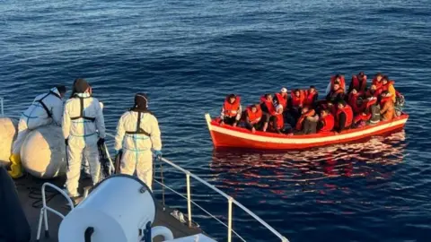 Italian coastguard  Italian coastguard rescuing migrants (file photo)