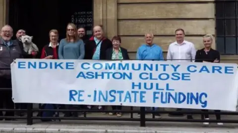 Endike Community Care A banner urging the council to reinstate funding