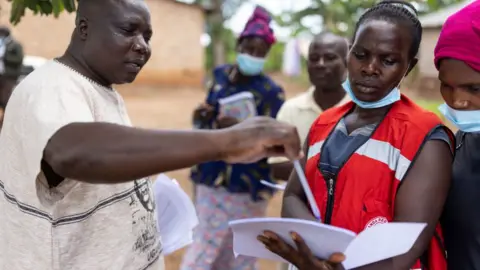 Getty Images Contact tracers attempt to find recent contacts of Ebola patients in Mubende, Uganda