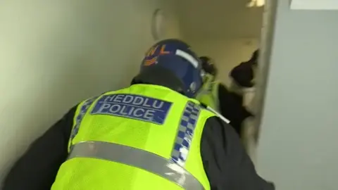 South Wales Police Another raid is carried out during the operation