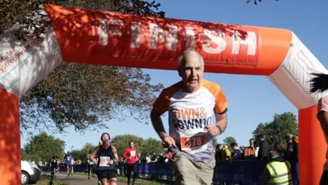 Marathon Photos John Dawson completing in the Town & Gown 10k race in October 2023