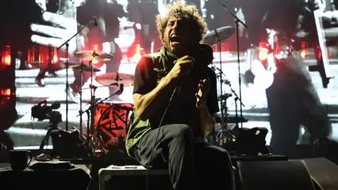 Getty Images Zack de la Rocha performing seated at Madison Square Garden in New York on 8 August