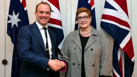 Getty Images Australia's Foreign Minister Marise Payne shakes hands with Britain's Foreign Secretary Dominic Raab