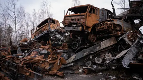 BBC / Claire Jude Press A graveyard of Russian vehicles from the convoy piled high in Hostomel