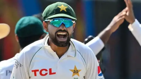 Babar Azam celebrates after taking the wicket of Sri Lanka's Dhananjaya de Silva during the fourth day of the second and final Test in Sri Lanka in July 2023
