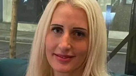 Portrait of blonde woman wearing silver pendant