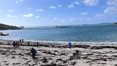Truro Cathedral Choir A beach on the Isles of Scilly with children playing and flying kites 