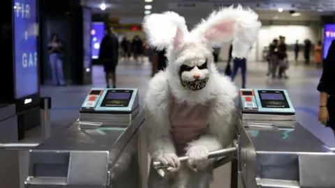 A person dressed up as a rabbit exits the subway in Sao Paulo, Brazil