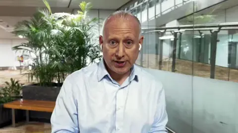 Steve Rosenberg in a room with a plant