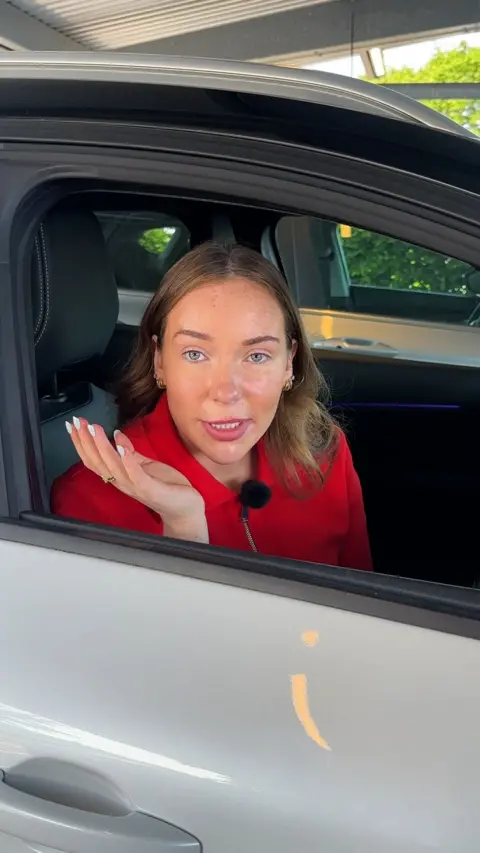Megan looking at camera out car window