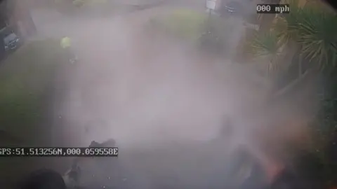 Image from CCTV footage showing fume  surrounding upside down   bin 