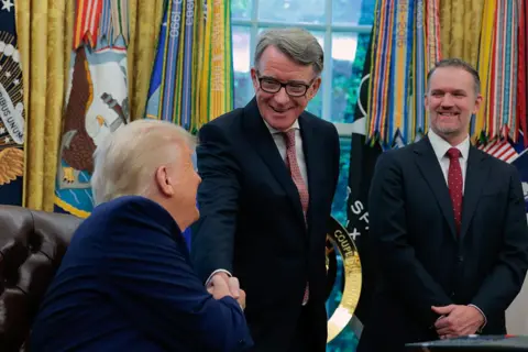President Donald Trump shakes hands with Peter Mandelson, British Ambassador to the United States