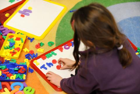 Child playing with letters