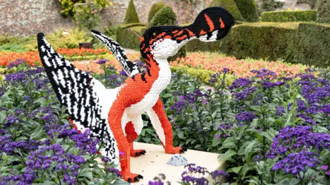 East Riding of Yorkshire Council Another Lego dinosaur with large wings and beak sits within a flower bed at the stately home.