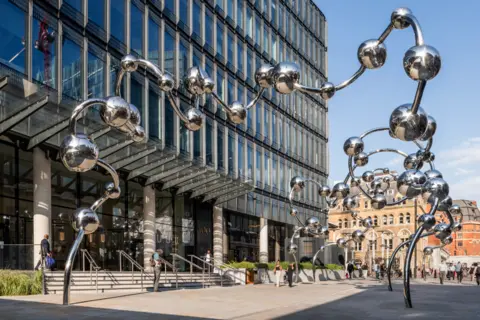 YAYOI KUSAMA. Courtesy Ota Fine Arts and Victoria Miro. Photo Thierry Bal   Gleaming silver spheres sculpture at Liverpool Street station