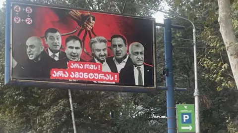 "No war, no agents" was the message beneath photos of six opposition leaders, each in chains