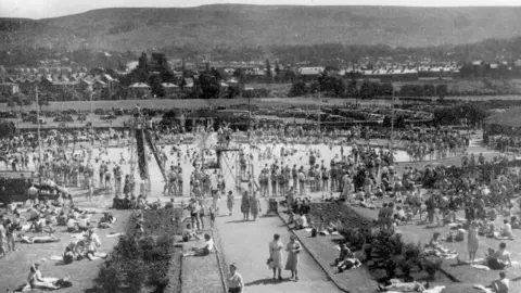 Bradford Council Black and white image showing hundreds of people gathered in and around a circular outdoor pool