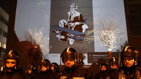 Reuters Humorous images of Viktor Orban were projected on the wall of the state TV building