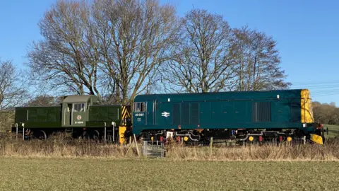 Caroline Warne A diesel locomotive train in a navy blue colour