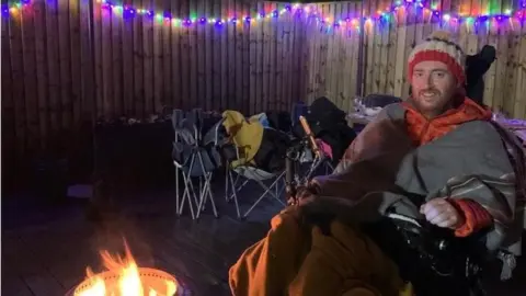 Family photo Alex Francis in his wheelchair