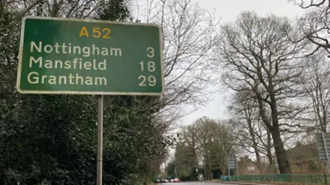 A sign on the A52 that shows from the sign it is three miles to Nottingham, 18 miles to Mansfield and 29 miles to Grantham. 