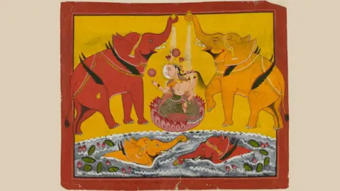The Trustees of the British Museum Gouache painting on paper depicting Gaja-Lakṣmī (Gajalakshmi); an image of the goddess Lakṣmī, who reigns over fertility and good fortune, seated on a lotus with an elephant (gajah in Sanskrit) on either side. They have small wings, a detail which recalls the myth in which the elephants freely roamed throughout the sky.