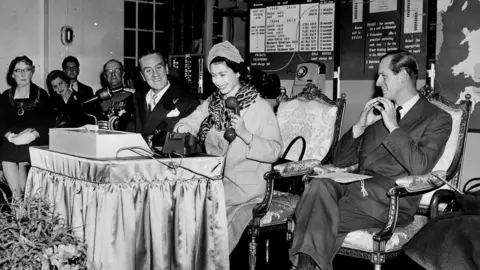 PA Media Photo dated 5/12/1958 of Queen Elizabeth II placing the first long-distance phone call made without the help of an operator at the central telephone exchange in Bristol.