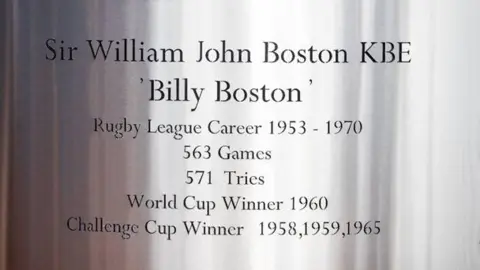 Cardiff Council A close up image of Sir Billy Boston's name on the statue in its updated form. It reads: Sir William John Boston KBE 'Billy Boston', Rugby League Career 1953 - 1970. 563 Games. 571 Tries. World Cup Winner 1960. Challenge Cup Winner 1958, 1959, 1965. 