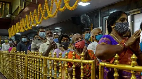 Hindu devotees visit the Tirumala Tirupati Devasthanams temple on the occasion of 'Ugadi' festival or new year's day as per the Hindu lunisolar calendar in Chennai on April 13, 2021.