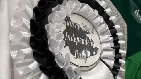 Richard Smith/BBC Canvey Island Independent Party rosette