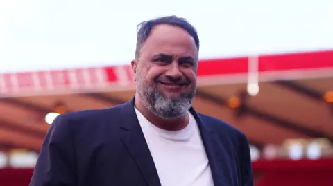 PA Media Forest owner Evangelos Marinakis smiling at the City Ground.