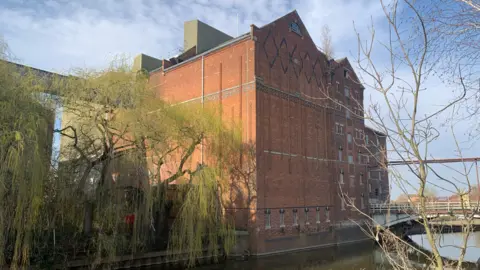 The former Borough Flour Mills building. It's a red-brick building by a river.