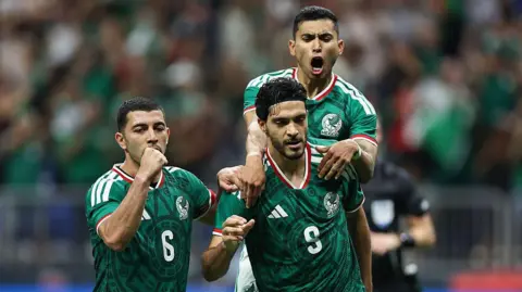 Raul Jimenez celebrates with his team-mates after scoring for Mexico against Paraguay in November 2025