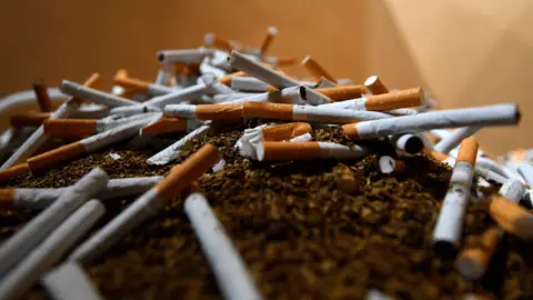 A pile of cigarettes atop a mound of tobacco