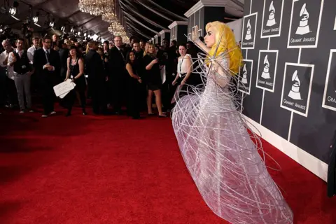 Getty Images Lady Gaga in a spider-web dress on the Grammys red carpet