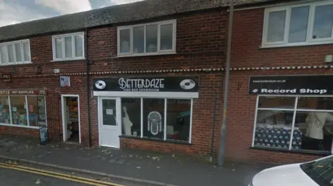 Google Google Street View image of Gary Lewis' record shop in Northallerton, a red-brick terraced shop with a juke box in the window and the name Betterdaze on a sign above.