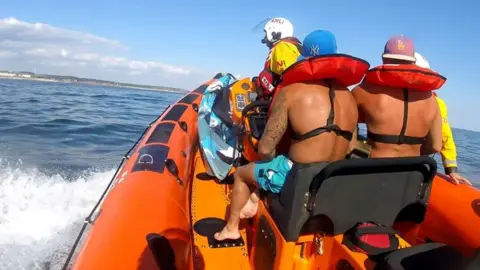 RNLI Porthcawl Two rescued men are taken back to shore by RNLI Porthcawl Atlantic 85 inshore boat